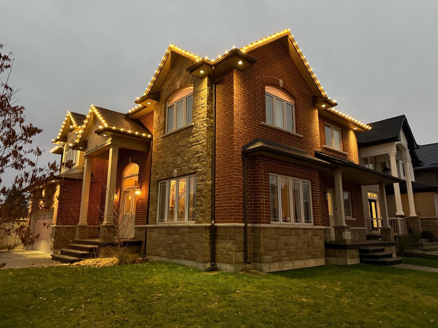 Commercial-grade Christmas tree lighting installation by Antoine Landscape Contractors