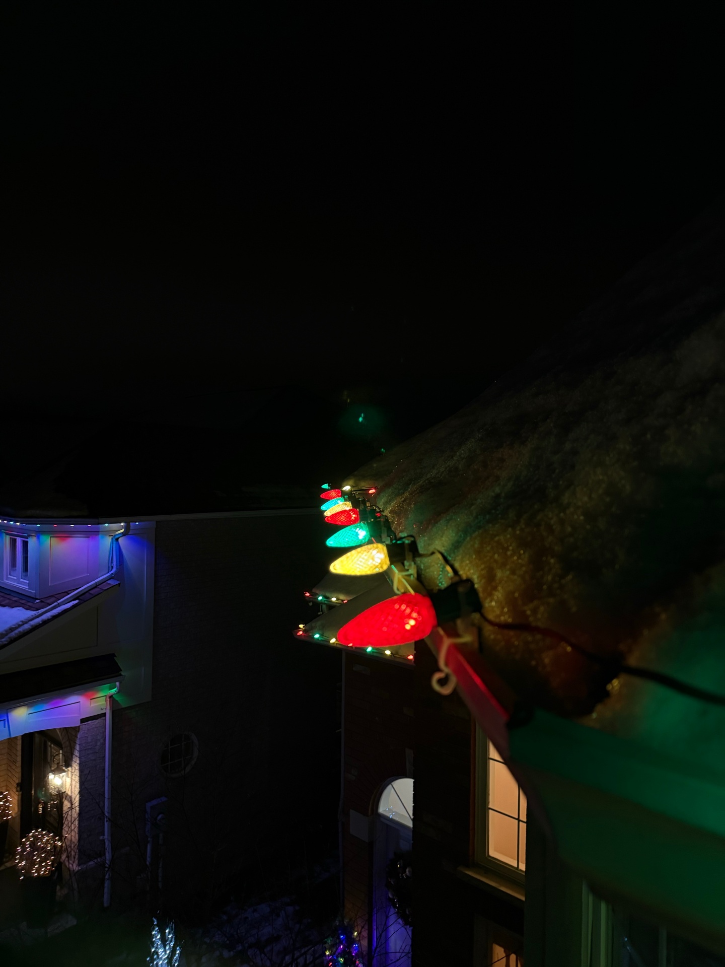 Multi-colour Christmas lights professionally installed on a Hamilton house